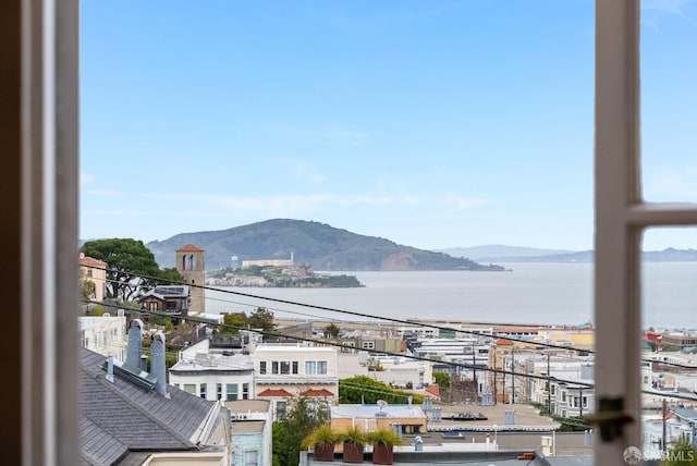 balcony featuring a water and mountain view