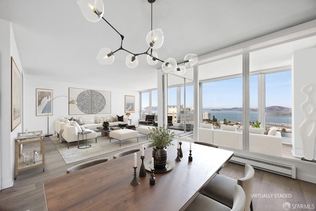 1070 Green St Unit 1001, San Francisco, CA 94133 - dining space featuring a water view, a baseboard heating unit, a wall of windows, and wood finished floors