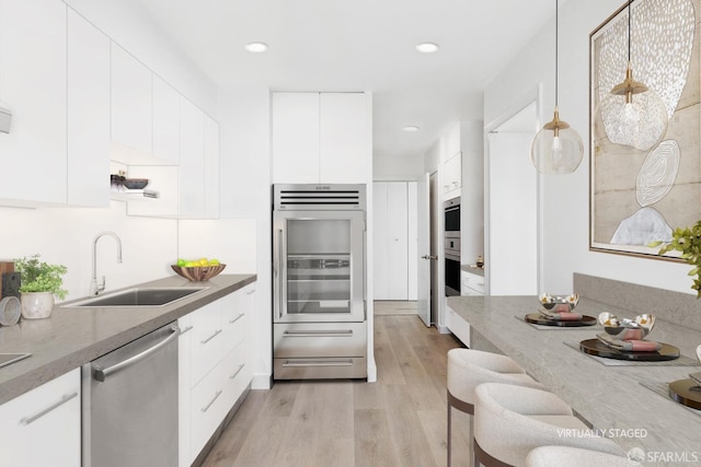 1070 Green St Unit 1001, San Francisco, CA 94133 - kitchen featuring stainless steel appliances, pendant lighting, a sink, and modern cabinets
