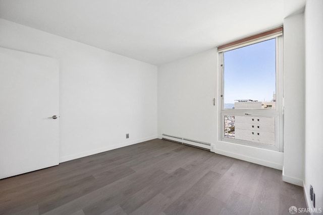 1070 Green St Unit 1001, San Francisco, CA 94133 - empty room featuring a baseboard radiator, baseboards, and wood finished floors