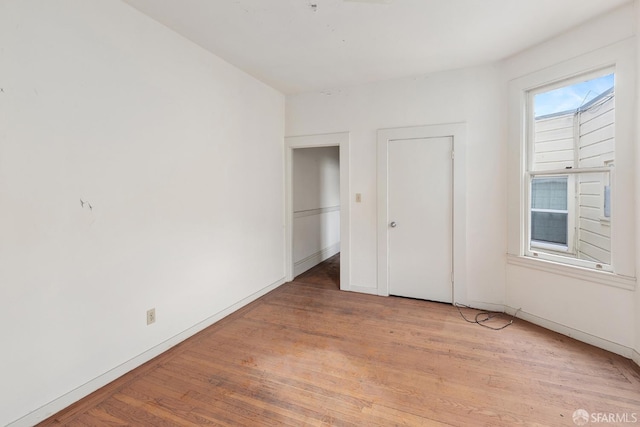 unfurnished bedroom featuring baseboards and light wood finished floors