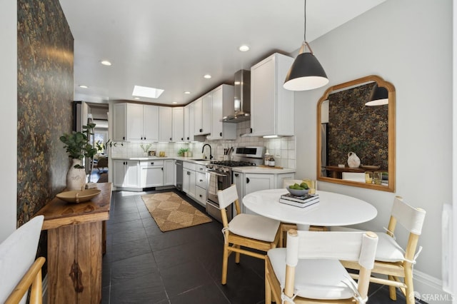 24 Mirabel Ave, San Francisco, CA 94110 - kitchen featuring stainless steel appliances, wall chimney exhaust hood, backsplash, light countertops, and white cabinets
