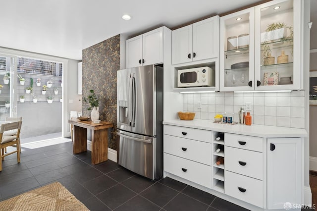 24 Mirabel Ave, San Francisco, CA 94110 - kitchen with stainless steel fridge, white microwave, light countertops, tasteful backsplash, and white cabinets