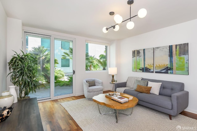 living room with plenty of natural light and wood finished floors