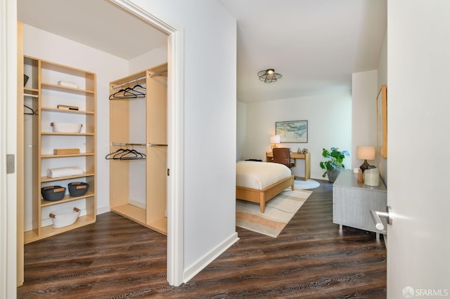bedroom with dark wood-type flooring
