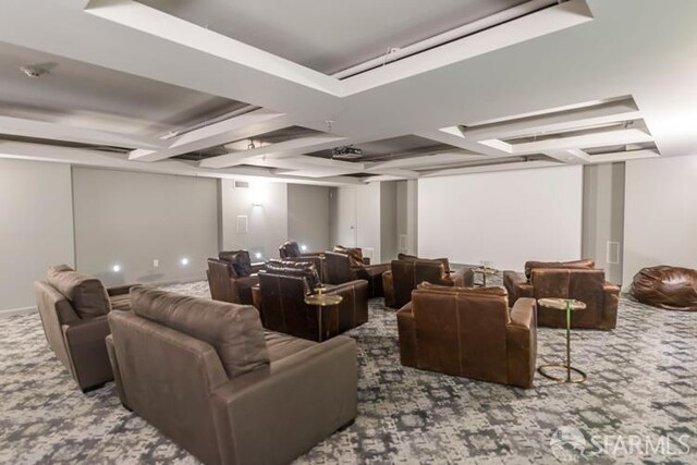 carpeted cinema with beam ceiling and coffered ceiling