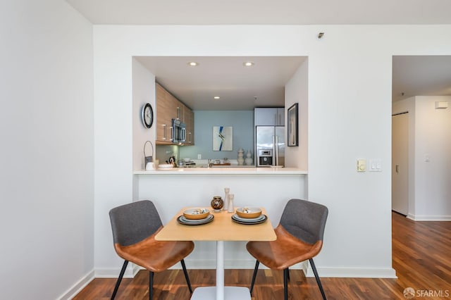 dining space with dark wood finished floors, recessed lighting, and baseboards
