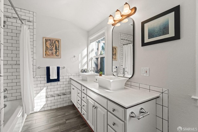 bathroom featuring shower / tub combo, vanity, and tile walls