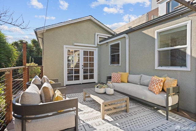 wooden terrace with french doors and an outdoor hangout area