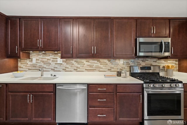 kitchen with decorative backsplash, appliances with stainless steel finishes, and sink