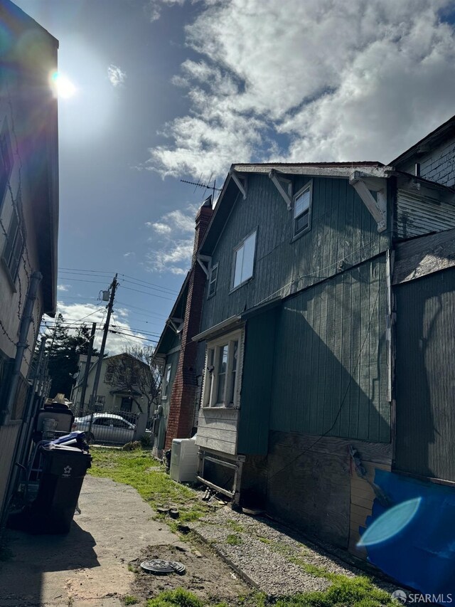 228 15th St, Richmond, CA 94801 - view of side of home with a chimney and central AC