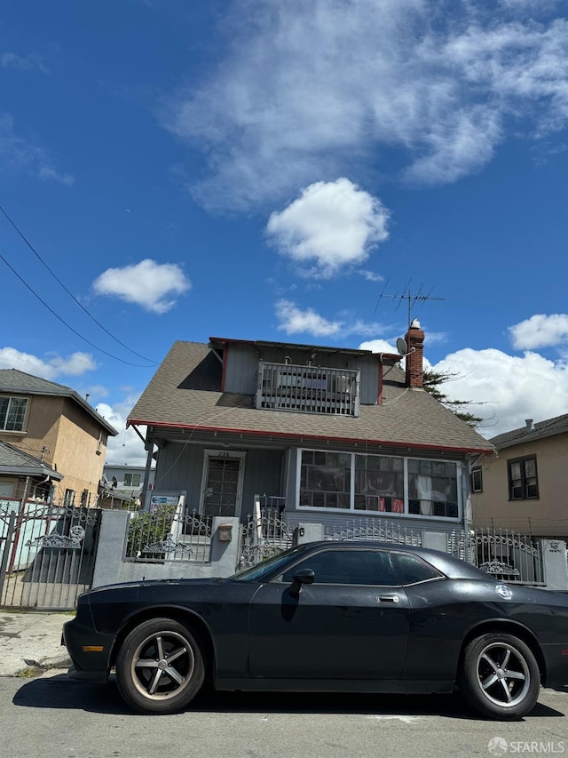 228 15th St, Richmond, CA 94801 - bungalow-style home featuring a chimney, a balcony, board and batten siding, and a shingled roof