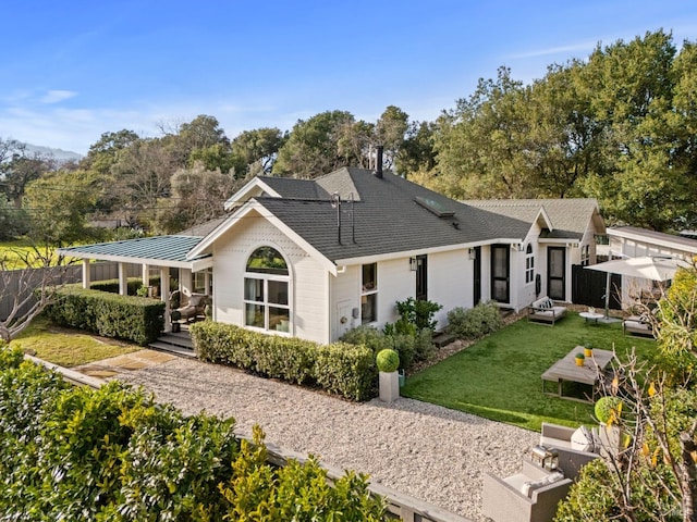 back of house with a patio area and a yard