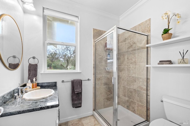 bathroom featuring a shower with shower door, vanity, toilet, and ornamental molding