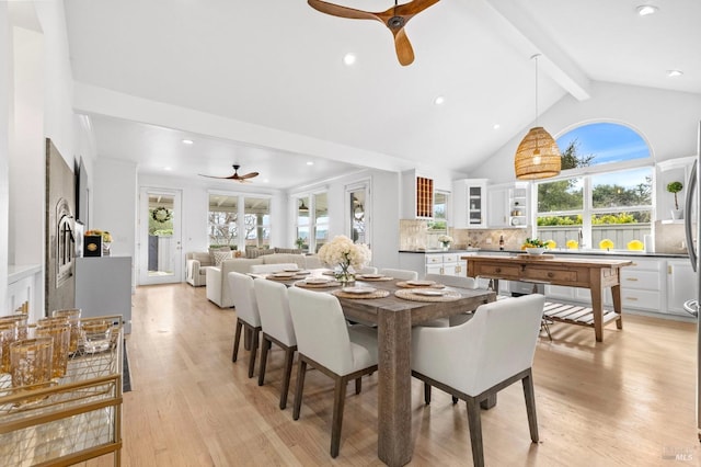 dining space featuring ceiling fan, plenty of natural light, beamed ceiling, and light hardwood / wood-style flooring