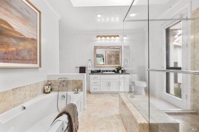 bathroom with toilet, ornamental molding, tiled tub, and vanity