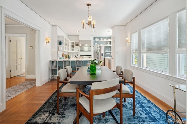 2932 Baker St, San Francisco, CA 94123 - dining area with a chandelier, wood finished floors, and baseboards