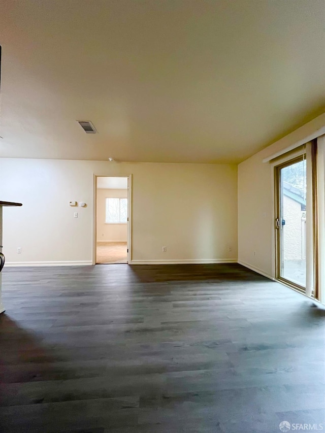 unfurnished room with dark hardwood / wood-style floors