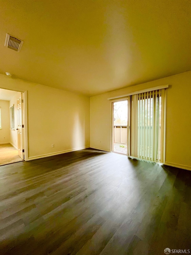 unfurnished room featuring dark hardwood / wood-style floors