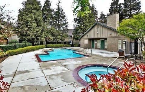 view of pool with a community hot tub and a patio area