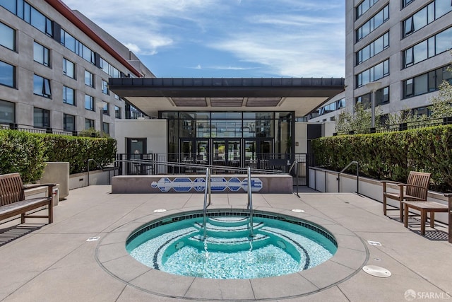 view of swimming pool with a patio area and a community hot tub