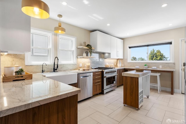4551 Fairbairn Ave, Oakland, CA 94619 - kitchen with appliances with stainless steel finishes, light stone counters, backsplash, pendant lighting, and open shelves