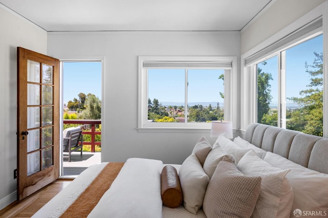4551 Fairbairn Ave, Oakland, CA 94619 - bedroom featuring multiple windows, access to exterior, ornamental molding, and wood finished floors
