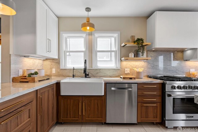 4551 Fairbairn Ave, Oakland, CA 94619 - kitchen featuring appliances with stainless steel finishes, decorative backsplash, light stone countertops, and white cabinetry