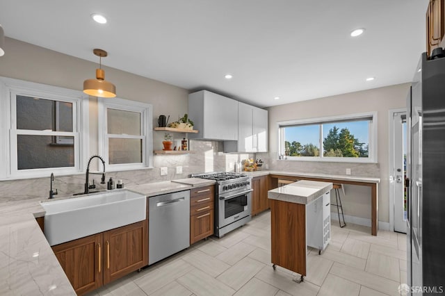 4551 Fairbairn Ave, Oakland, CA 94619 - kitchen featuring stainless steel appliances, decorative backsplash, pendant lighting, light stone countertops, and recessed lighting