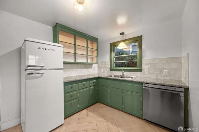 4551 Fairbairn Ave, Oakland, CA 94619 - kitchen with freestanding refrigerator, stainless steel dishwasher, and tasteful backsplash
