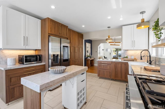4551 Fairbairn Ave, Oakland, CA 94619 - kitchen with stainless steel appliances, a peninsula, decorative backsplash, pendant lighting, and recessed lighting
