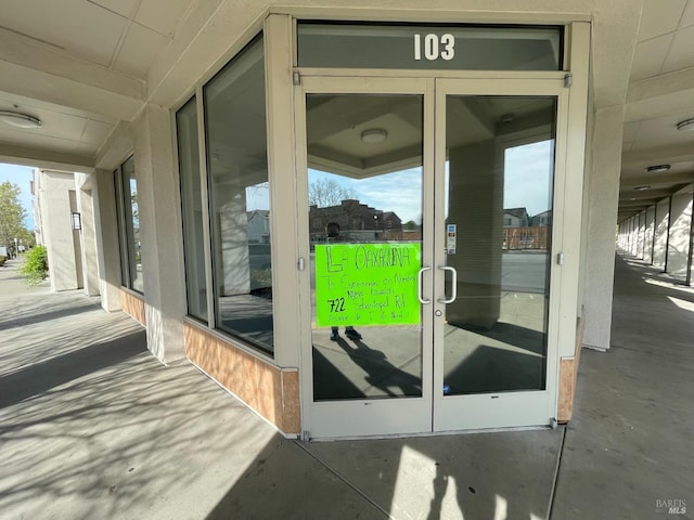 property entrance featuring french doors