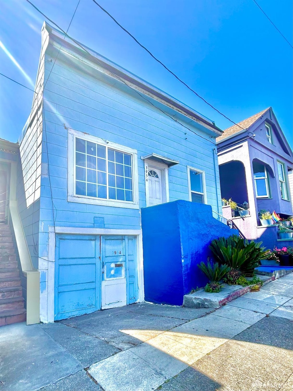 3954 Folsom St, San Francisco, CA 94110 - view of front facade with concrete driveway and an attached garage