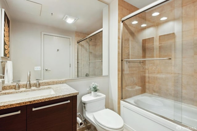 full bathroom with toilet, combined bath / shower with glass door, and vanity