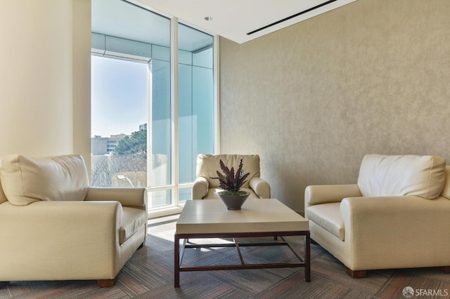 sitting room featuring a healthy amount of sunlight and floor to ceiling windows