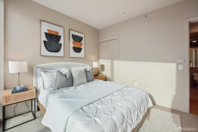 bedroom featuring a closet and light carpet