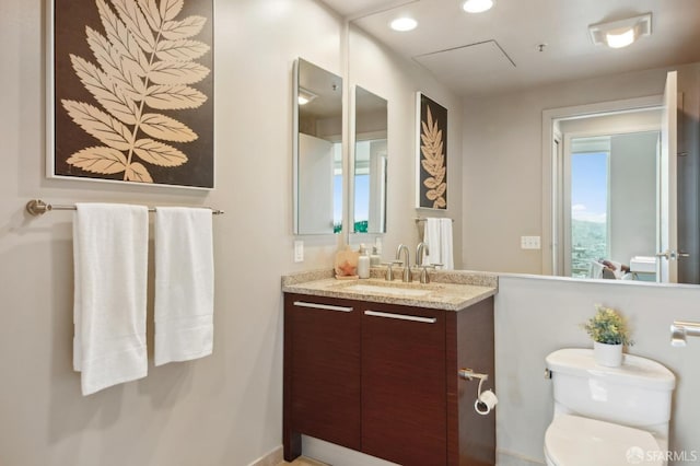 bathroom featuring toilet and vanity