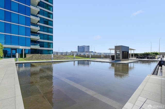 view of swimming pool with a water view