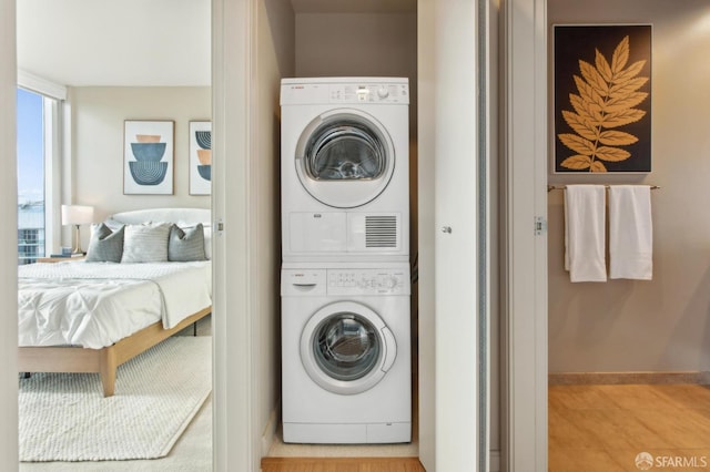 laundry room with stacked washer / drying machine