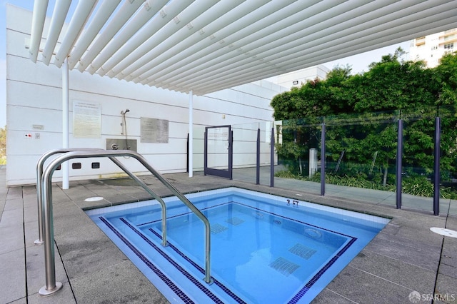 view of swimming pool featuring a community hot tub