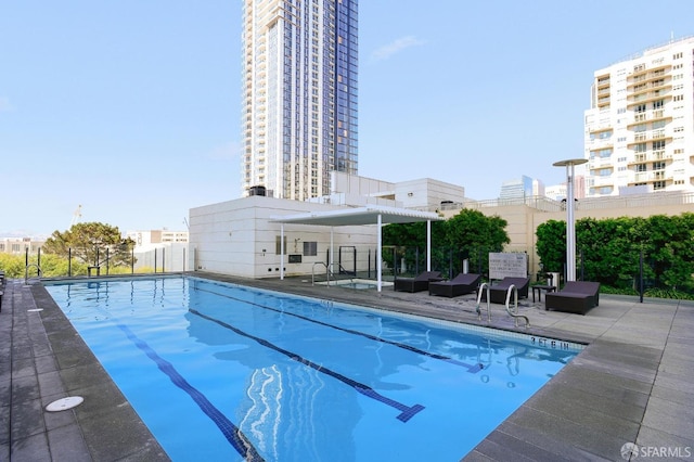 view of pool with a pergola and a patio