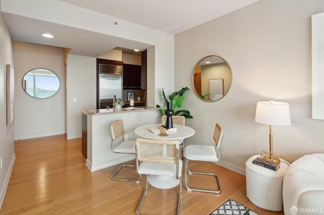 dining area with light hardwood / wood-style floors