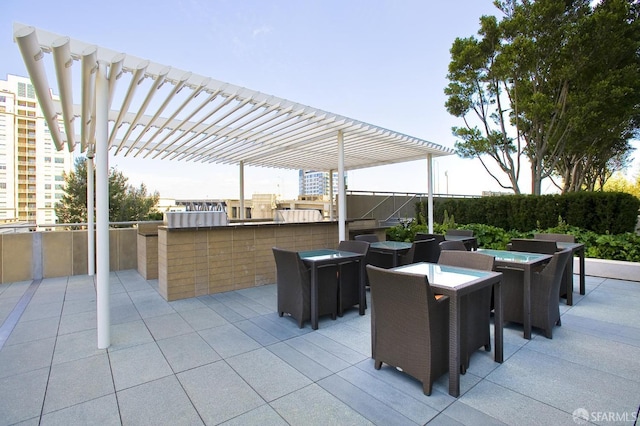 view of patio / terrace featuring exterior bar and a pergola