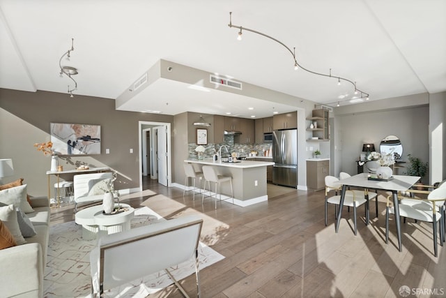 dining space with light hardwood / wood-style floors and sink