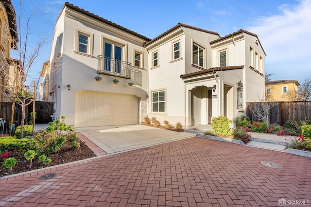 view of front of home with a garage and a balcony