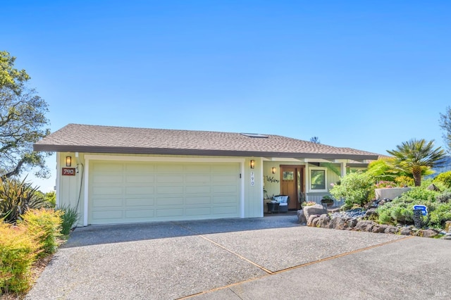 ranch-style home with driveway and a garage