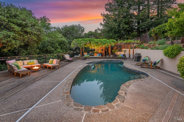 view of pool with a deck, a fenced backyard, an outdoor hangout area, a fenced in pool, and a patio area