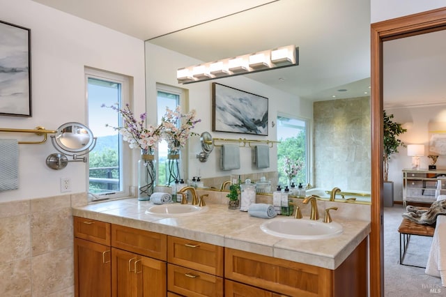 full bathroom with double vanity and a sink