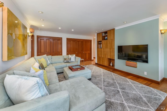 living area with recessed lighting, ornamental molding, baseboards, and wood finished floors