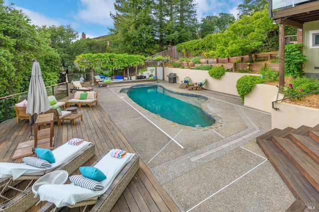 view of pool featuring a fenced in pool, a fenced backyard, a patio area, and a wooden deck